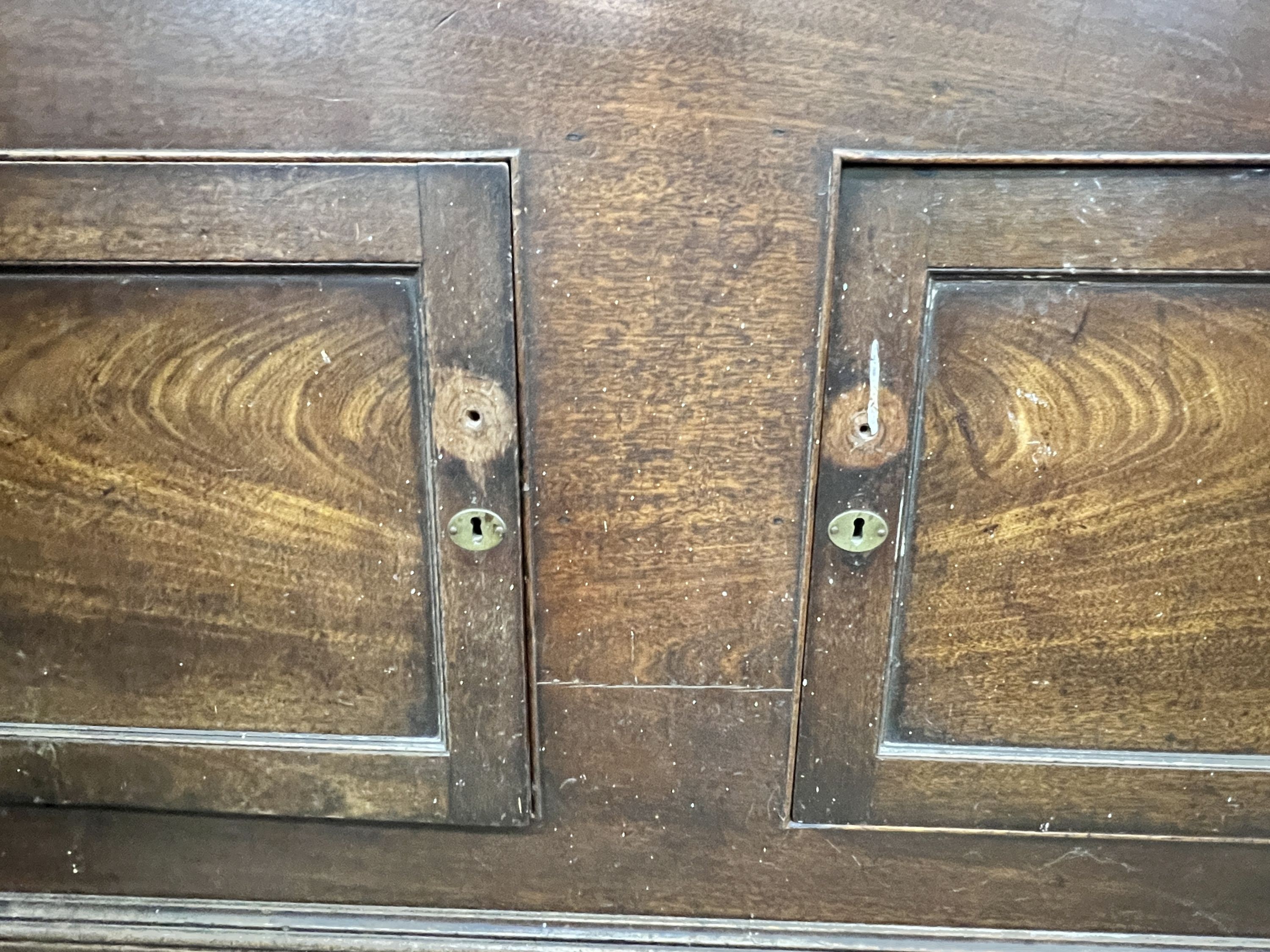 A mid 18th century fruitwood mule chest, adapted, with two panelled doors over three drawers, width 156cm, depth 57cm, height 124cm